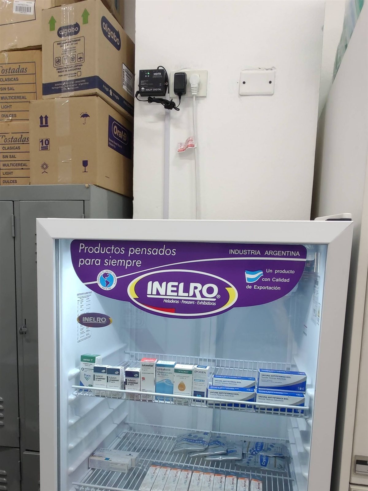 Equipo MDTR montado en pared junto a heladera de medicamentos, con el sensor NTC instalado dentro